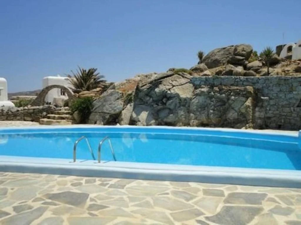 Natural stone surrounding a shared pool