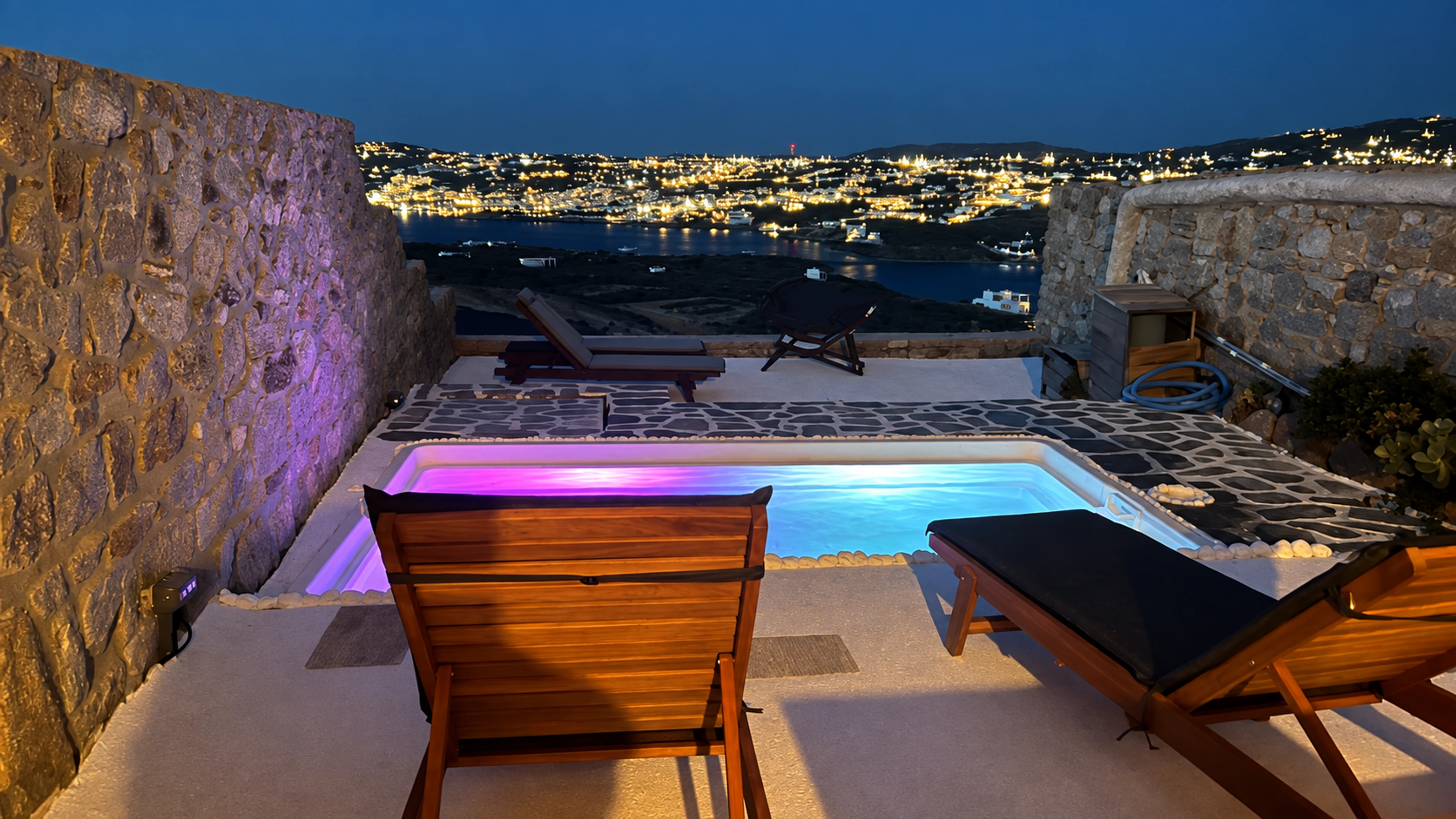 Nalu’s illuminated private pool and loungers overlooking the island lights