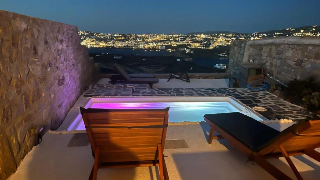 Loungers beside the illuminated private pool